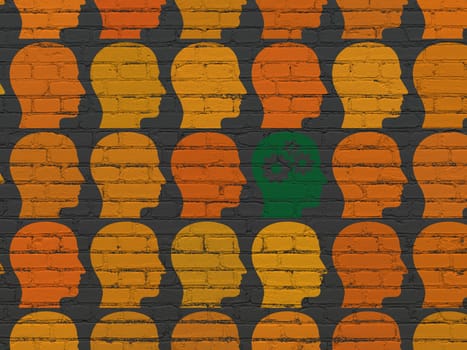 Finance concept: rows of Painted orange head icons around green head with gears icon on Black Brick wall background