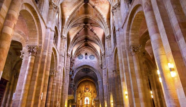 Basilica Arches Columns Statue Cathedral Avila Castile Spain  Gothic church built in the 1100s.  Avila is a an ancient walled medieval city in Spain.
