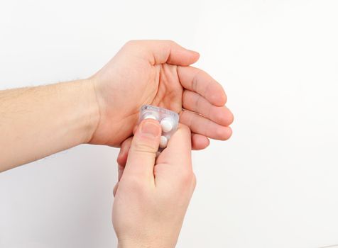 Pack of pill in hand on white background