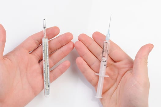 thermometer and syringe in hand on white background