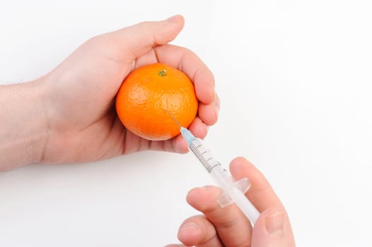 mandarin  get shot with syringe on white background