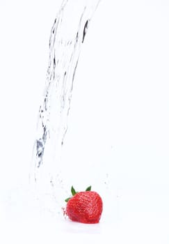 Red strawberry in flowing water on white background