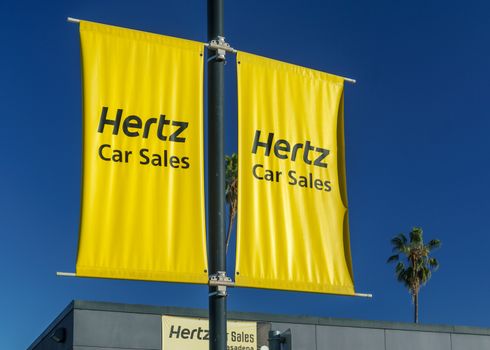 PASADENA, CA/USA - JANUARY 2, 2016: Hertz Car Sales sign and logo. The Hertz Corporation is an American car rental company.