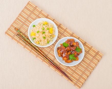 General Tao chicken and vegetable fried rice photographed from overhead.