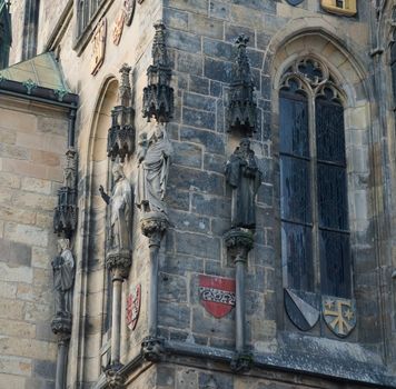 Statues and decor on the walls of old Prague town hall