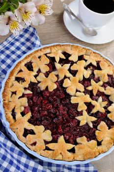 pie with cherry filling decorated flowers and petals  