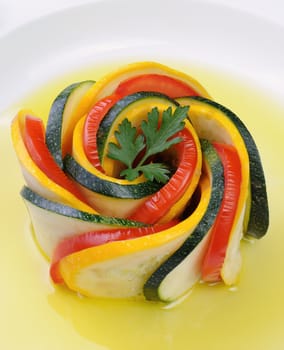 Appetizer twisted into a spiral of zucchini, tomato and sauce