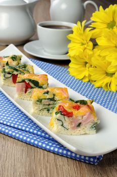 Canape of omelet with spinach, sausage and a cup of coffee