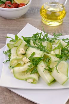 Salad from zucchini ribbon with arugula and feta