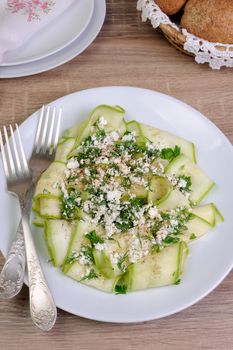 Salad with strips of zucchini, ricotta, dill and spices