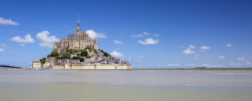 Panoramic view of Mont-Saint-Michel with blue sky, France.
