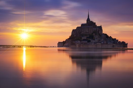 View of famous Mont-Saint-Michel at sunset, France.