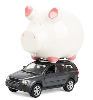 Piggy bank on car isolated on white background