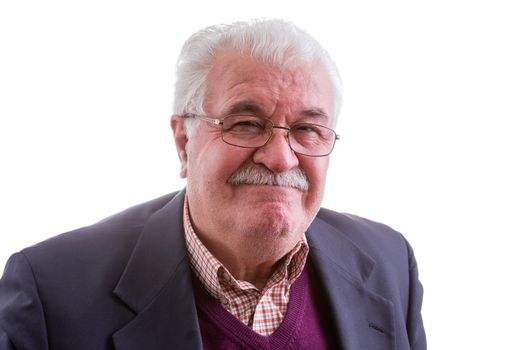 Dissatisfied distinguished white-haired senior man grimacing in disapproval as he looks at the camera, head and shoulders isolated on white