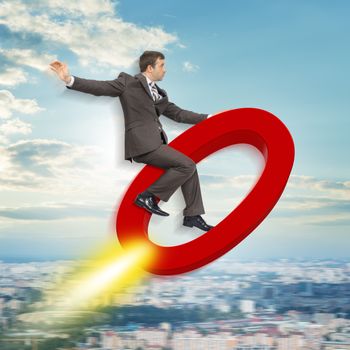 Businessman flying on zero sign above city