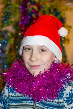 The teenage boy's portrait in a Christmas red hat