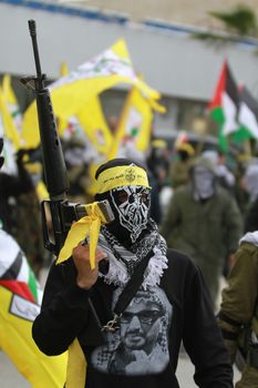 WEST BANK, Bethlehem: Palestinian supporters of the Fatah movement rally in Bethlehem, the West Bank to celebrate the group's 51st anniversary on January 7, 2016. A secular faction of the Palestine Liberation Organization, its members wear masks, while touting guns and flags that bore the party brand at the rally.