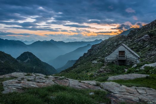 refuge on mountain alps at sunset or sunrise