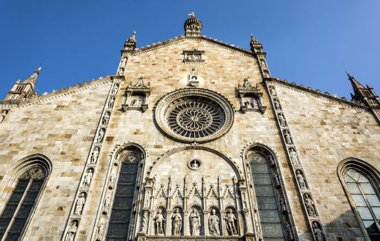 Como Cathedral is the Roman Catholic cathedral of the city of Como, Lombardy, Italy, and the seat of the Bishop of Como. It is dedicated to the Assumption of the Blessed Virgin Mary.
The cathedral, located near Lake Como, is one of the most important buildings in the region. It is commonly described as the last Gothic cathedral built in Italy: construction on it, on the site of the earlier Romanesque cathedral dedicated to Santa Maria Maggiore, began in 1396, 10 years after the foundation of Milan Cathedral. The construction works, started under the supervision of Lorenzo degli Spazzi di Laino, did not finish until 1770 with the completion of the Rococo cupola by Filippo Juvarra.[1] The imposing west front was built between 1457 and 1498 and features a rose window and a portal between two statues of Pliny the Elder and Pliny the Younger, natives of Como.