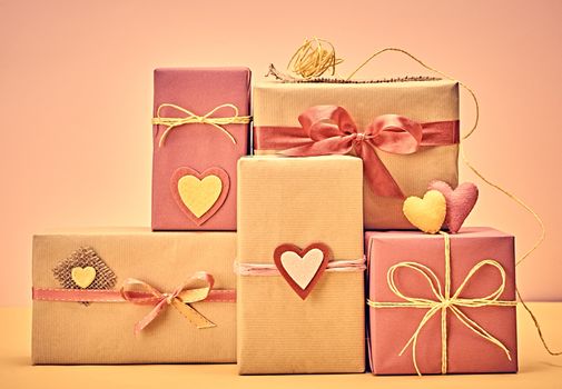 Love hearts, Valentines Day. Handcraft gift boxes, presents stack. Couple of hearts. Retro romantic styled. Vintage retro concept, unusual greeting card. Kraft paper, multicolored felt, copyspase
