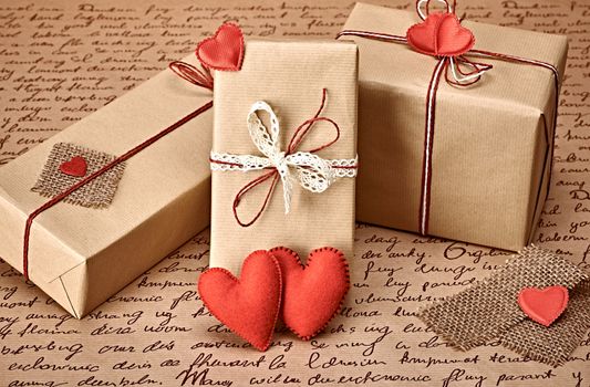 Love hearts, Valentines Day. Handcraft gift boxes, presents. Couple of red felt hearts. Retro romantic styled. Vintage retro concept, unusual greeting card. Kraft paper, copyspase