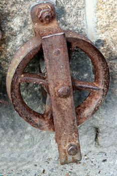 Old and rusted.

Iron contraption used in the port of Looe, Cornwall, probably in relation to the loading of granite onto ships in the 19th century.