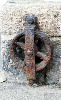 Old and rusted.

Iron contraption used in the port of Looe, Cornwall, probably in relation to the loading of granite onto ships in the 19th century.