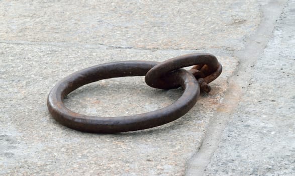 Old and rusted.

Iron ring in the port of Looe, Cornwall, used to tying up of boats to harbour.