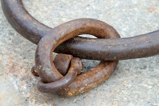 Old and rusted.

Iron ring in the port of Looe, Cornwall, used to tying up of boats to harbour.