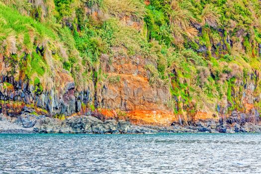 Colorful rocky cliff coast of Madeira between Jardim do Mar and Calheta
