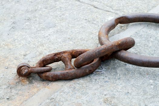 Old and rusted.

Iron ring in the port of Looe, Cornwall, used to tying up of boats to harbour.