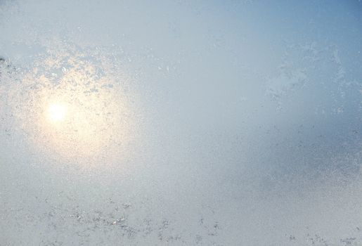 Frozen window covered with frost in winter patterned.