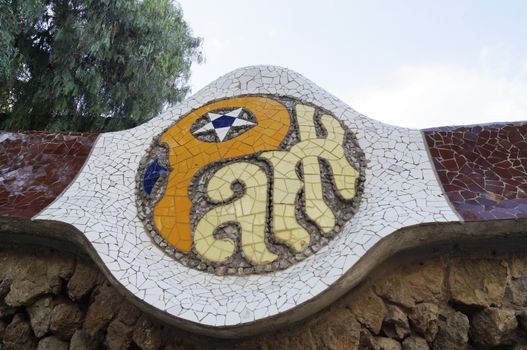  BARCELONA, SPAIN - OCTOBER 08, 2015: Mosaic sign of Park Guell in Barcelona, Spain, designed by famous architect Antoni Gaudi