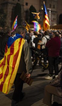 SPAIN, Barcelona: A man wears a pro-independence flag on his back as an estimated one thousand people rally for Catalan independence in the plaza of the Cathedral of Barcelona in Spain on January 7, 2016. Protesters push for an agreement between the pro-independence Together For Yes (Junts pel Si) and Popular Unity Candidacy (CUP) parties for the formation of a new government; and the prevention of elections to be held on March.