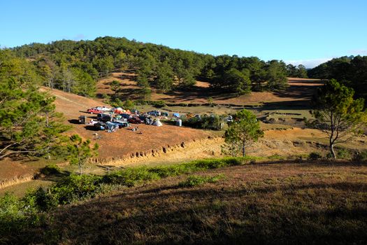 DA LAT, VIET NAM- JAN 2: Group of person  in family vacation in spring, people with 4x4 terrain car camp at pine forest, exciting experience in eco travel with tent, Dalat, Vietnam, Jan 2, 2016