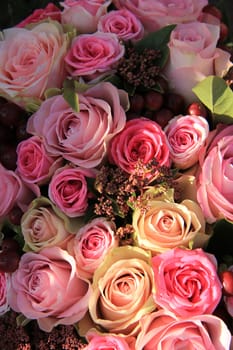 Pastel roses in different shades of pink in a bridal arrangement