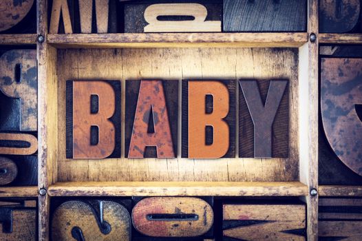 The word "Baby" written in vintage wooden letterpress type.