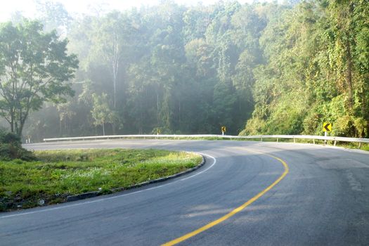 Curved road in winter is empty.