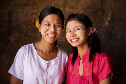 Young Myanmar girls with Thanaka, a yellowish-white paste made from ground bark and used as a cosmetic and for sunburn protection.