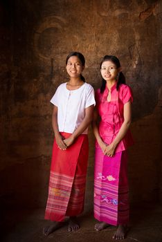 Full length portrait of beautiful young traditional Myanmar girls smiling. 