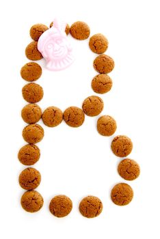 Ginger nuts, pepernoten, in the shape of letter B isolated on white background. Typical Dutch candy for Sinterklaas event in december