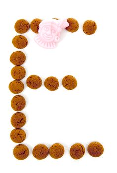 Ginger nuts, pepernoten, in the shape of letter E isolated on white background. Typical Dutch candy for Sinterklaas event in december