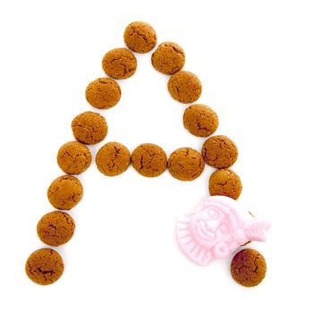 Ginger nuts, pepernoten, in the shape of letter A isolated on white background. Typical Dutch candy for Sinterklaas event in december