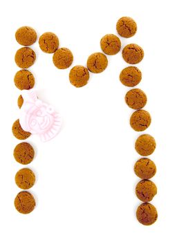 Ginger nuts, pepernoten, in the shape of letter A isolated on white background. Typical Dutch candy for Sinterklaas event in december