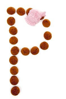 Ginger nuts, pepernoten, in the shape of letter P isolated on white background. Typical Dutch candy for Sinterklaas event in december