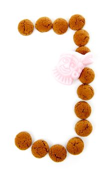 Ginger nuts, pepernoten, in the shape of letter J isolated on white background. Typical Dutch candy for Sinterklaas event in december