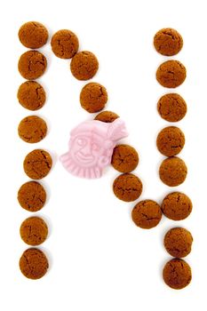 Ginger nuts, pepernoten, in the shape of letter N isolated on white background. Typical Dutch candy for Sinterklaas event in december