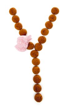 Ginger nuts, pepernoten, in the shape of letter Y isolated on white background. Typical Dutch candy for Sinterklaas event in december