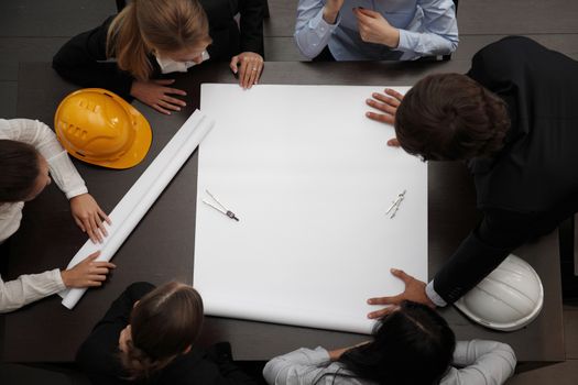 Top view of people around table in construction business meeting