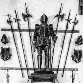 Medieval armor exposed along with metal halberds.